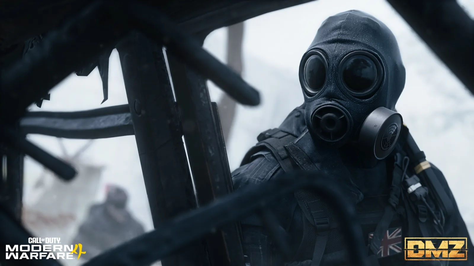 An operator in a gas mask moves past charred timber beams in DMZ